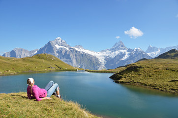 Traveler in the Alpine meadow. Jungfrau region, Switzerland
