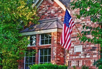 American flag hanging on the front of the house