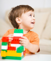 Boy is playing with building blocks