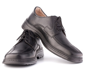 Black glossy man’s shoes with shoelaces