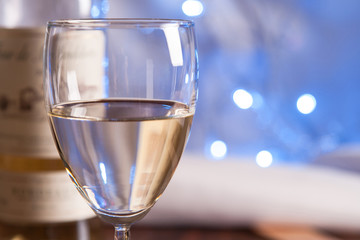 glass and bottle white wine on blink light