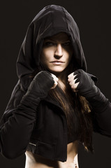 Studio shot of a beautiful serious woman getting ready to fight.