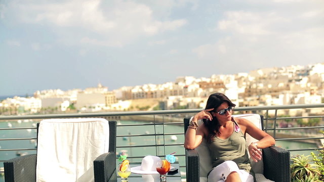Alone woman sitting on the terrace and waiting for someone, cran
