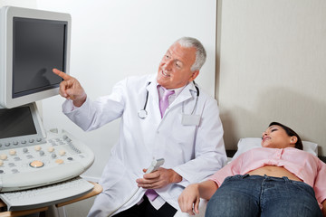 Radiologist With Female Patient At Clinic