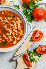 Close-up on sliced ​​fresh tomatoes and tomato soup made ​