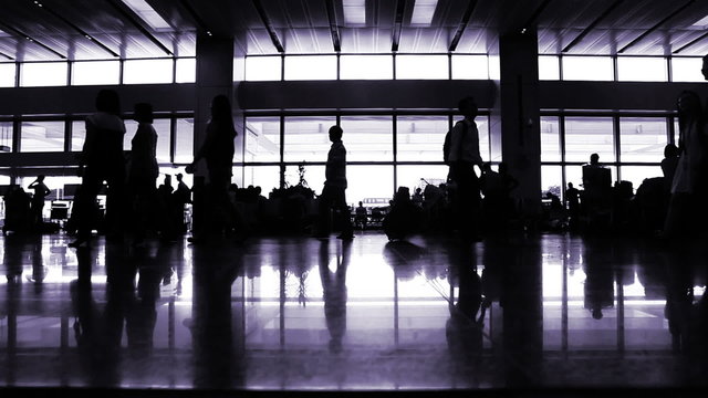 Passengers walking and waiting in international terminal hall