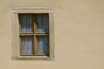 Fototapeta na wymiar Wooden window in the wall of the castle