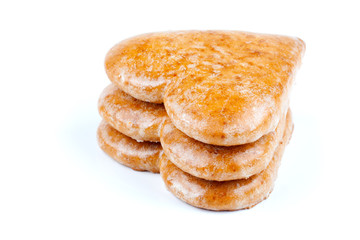 Cookies-hearts connected by a red tape on a white background