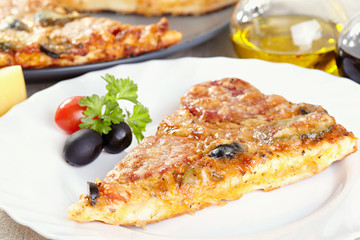 Italian cuisine. Pizza with salami, pickles and olives