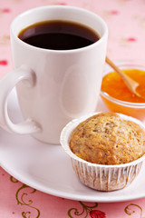 Fresh vegan banana muffin with a cup of coffee
