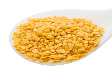 Yellow lentils in a spoon