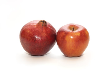 pomegranate and red apple isolated on the white background