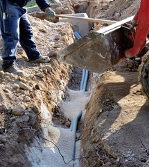Builder installing water pipes