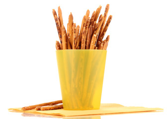 Tasty crispy sticks in yellow plastic cup isolated on white