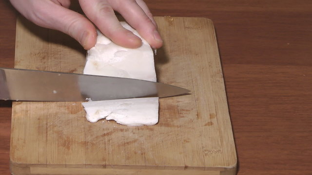 Pork fat cutting by a knife.