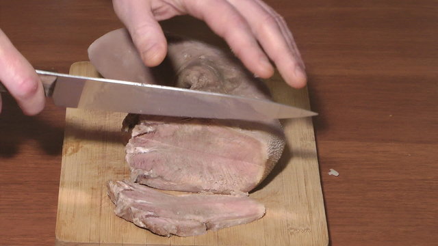 Cutting of boiled beef tongue.