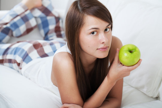 Beautiful young woman with apple