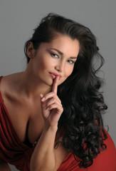 Naklejka premium Portrait of sexy Asian brunette at grey background