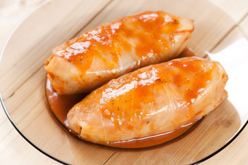 Stuffed cabbages with tomato sauce on a plate, studio shot