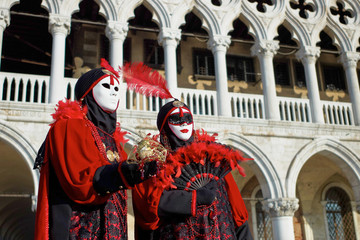 Person in Venetian costume attends Carnival of Venice.