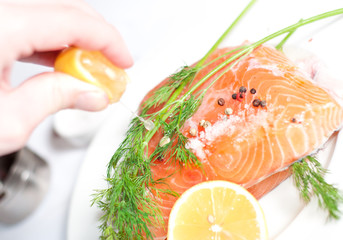 Fresh salmon red fish with lemon and spices