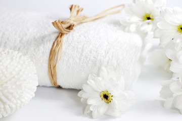 Towel and flowers spa bath concept on white background