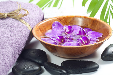 Orchids in the bowl with towel spa cosmetic concept