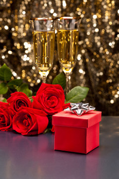 Red present box Champagne and roses