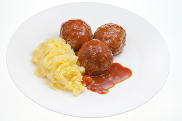 meatballs under meat sauce and mashed potatoes