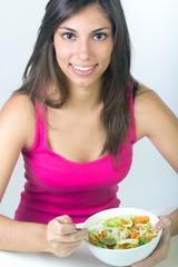 Obraz na płótnie Canvas young beautiful woman eating salad at home 