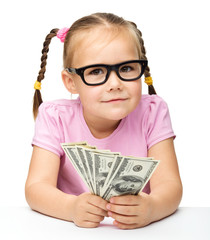 Little girl is counting dollars