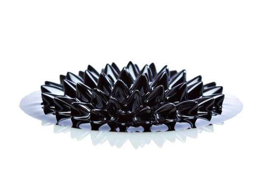 Macro of Ferrofluid on white surface - Powered by Adobe