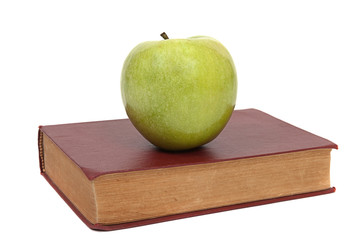 old book and green apple