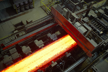 Hot steel on the production line. - obrazy, fototapety, plakaty