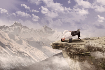Businessman relaxing on mountain