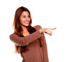 Smiling young woman pointing and looking left