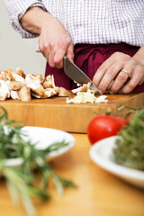 Man Cutting Mushrooms On Chopping Board