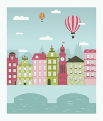 Hot air balloons flying over the little town.