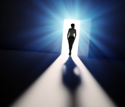 Woman walking into light