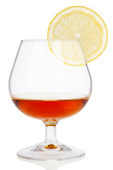 Cognac glass with lemon isolated on white