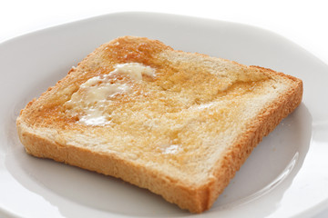 Slice of white buttered toast on a plate
