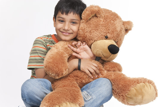 Indian Boy Holding Teddy Bear In Indoors