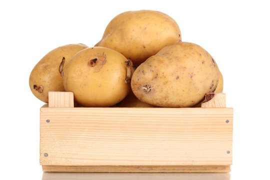 Ripe potatoes on wooden box isolated on white