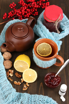 Helpful tea with jam for immunity on wooden table close-up