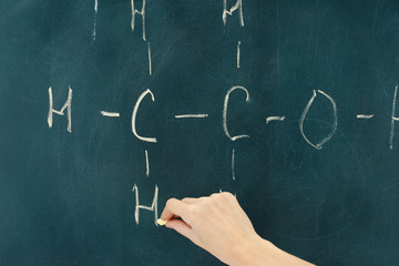Chemical structure formula written on blackboard with chalk.
