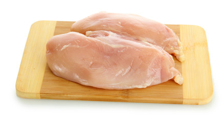 raw chicken meat on cutting board, isolated on white