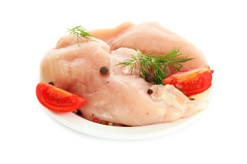 raw chicken meat with spices on plate, isolated on white