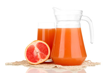 Full glass and jug of grapefruit juice and grapefruits isolated