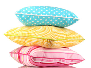 Blue, pink and yellow bright pillows isolated on white