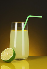 Delicious lemon juice in glass and lime next to it